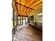 Screened-in porch with wooden floors and ceiling fan; relaxing outdoor living space at 10560 Haynes Bridge Rd, Alpharetta, GA 30022
