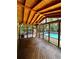 Screened-in porch with view of the in-ground pool and wooded backyard at 10560 Haynes Bridge Rd, Alpharetta, GA 30022