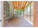 Covered screened-in porch featuring wood ceiling and serene views of backyard at 10560 Haynes Bridge Rd, Alpharetta, GA 30022