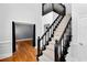 Grand staircase with black banister and white carpet creates a stunning entrance at 10560 Haynes Bridge Rd, Alpharetta, GA 30022