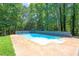 Private in-ground swimming pool surrounded by a concrete patio, perfect for summer relaxation and entertaining at 10560 Haynes Bridge Rd, Alpharetta, GA 30022
