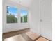 A bright bedroom with hardwood floors and large windows that fill the space with natural light and pleasant outdoor views at 2328 Lakewood Sw Ave, Atlanta, GA 30315