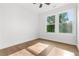 Well-lit bedroom with beautiful hardwood floors and white walls, offering a peaceful view from the double windows at 2328 Lakewood Sw Ave, Atlanta, GA 30315