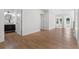 Bright hallway with hardwood floors leading to a bathroom and a room with plenty of sunlight streaming through its windows at 2328 Lakewood Sw Ave, Atlanta, GA 30315
