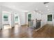 Bright hallway featuring beautiful wood floors, recessed lighting, and contrasting dark metal railing at 2328 Lakewood Sw Ave, Atlanta, GA 30315