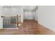 A hallway showcasing wood floors, white walls, doors, and contrasting dark metal railing at 2328 Lakewood Sw Ave, Atlanta, GA 30315