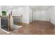 Hallway view featuring lovely wood floors, neutral paint color, and contrasting dark metal railing at 2328 Lakewood Sw Ave, Atlanta, GA 30315