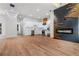 Open-concept kitchen featuring a fireplace, stainless steel appliances, and modern lighting fixtures at 2328 Lakewood Sw Ave, Atlanta, GA 30315