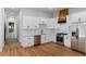 Well-equipped kitchen with white cabinets, stainless steel appliances, and a wood-paneled range hood at 2328 Lakewood Sw Ave, Atlanta, GA 30315