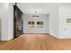 Bright living room features an elegant chandelier, black fireplace accent wall, and modern fixtures at 2328 Lakewood Sw Ave, Atlanta, GA 30315