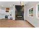 Modern living area featuring a black fireplace accent wall and stainless steel appliances at 2328 Lakewood Sw Ave, Atlanta, GA 30315