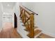 A staircase featuring eye-catching wooden handrails contrasted against the white walls and sleek wood flooring at 2328 Lakewood Sw Ave, Atlanta, GA 30315