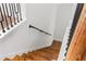 Stairway showcasing wooden stairs with black metal railing and white walls and baseboards at 2328 Lakewood Sw Ave, Atlanta, GA 30315