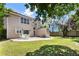 Lush backyard with a patio area, storage shed, and a mix of greenery and trees at 424 Citronelle Dr, Woodstock, GA 30188