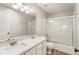 Bright bathroom featuring a double sink vanity and a glass-enclosed shower at 424 Citronelle Dr, Woodstock, GA 30188