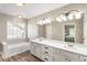 Bathroom with double vanity, soaking tub, and a large window at 424 Citronelle Dr, Woodstock, GA 30188