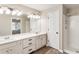 Bathroom featuring a double vanity, walk-in shower, and updated lighting at 424 Citronelle Dr, Woodstock, GA 30188