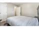 Clean bedroom with a queen bed and two doors, illuminated by soft, natural light at 424 Citronelle Dr, Woodstock, GA 30188