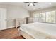 Bright bedroom featuring wood floors, vaulted ceiling, and a large window at 424 Citronelle Dr, Woodstock, GA 30188
