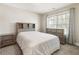 Neutral bedroom with a decorative headboard, matching dressers, and plush carpet at 424 Citronelle Dr, Woodstock, GA 30188