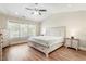 Bedroom with vaulted ceiling, ceiling fan, light-colored furnishings and large window at 424 Citronelle Dr, Woodstock, GA 30188