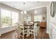 Spacious dining area featuring a chandelier and ample natural light, perfect for entertaining guests at 424 Citronelle Dr, Woodstock, GA 30188