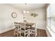 Bright dining room with a modern chandelier, hardwood floors, and natural light at 424 Citronelle Dr, Woodstock, GA 30188