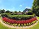 Beautiful landscaped entrance to The Park at Kingsgate features colorful flower beds and manicured shrubs at 424 Citronelle Dr, Woodstock, GA 30188