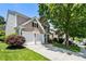 Charming home featuring a two-car garage, well-maintained lawn, and mature trees in a desirable neighborhood at 424 Citronelle Dr, Woodstock, GA 30188