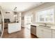 Bright kitchen features a white island, and is open to the living room at 424 Citronelle Dr, Woodstock, GA 30188