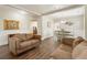 Bright and airy living room showcasing hardwood floors, modern decor, and a seamless flow to the dining area at 424 Citronelle Dr, Woodstock, GA 30188