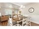 Open-concept living and dining area with hardwood floors and natural light from large windows at 424 Citronelle Dr, Woodstock, GA 30188