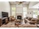 Bright living room with fireplace and lots of natural light from large windows at 424 Citronelle Dr, Woodstock, GA 30188
