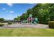 Bright and colorful community playground with multiple slides, climbing structures, and a soft landing surface at 424 Citronelle Dr, Woodstock, GA 30188