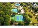 Aerial view of community tennis courts and basketball court surrounded by lush greenery and mature trees at 424 Citronelle Dr, Woodstock, GA 30188