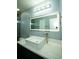 Well-lit bathroom featuring modern mirror, faucet, and vanity sink at 10770 Glenhurst Pass, Duluth, GA 30097