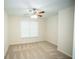 Cozy bedroom featuring neutral carpet, ceiling fan, and bright natural light at 10770 Glenhurst Pass, Duluth, GA 30097