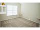 Comfortable bedroom with neutral carpet, shelves, and a window at 10770 Glenhurst Pass, Duluth, GA 30097