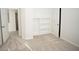 Bright bedroom features neutral carpeting, built-in shelves, and crisp white trim at 10770 Glenhurst Pass, Duluth, GA 30097