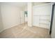 Bedroom with built-in shelving, neutral carpet, and access to hallway at 10770 Glenhurst Pass, Duluth, GA 30097