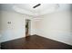 Spacious dining room with modern light fixture, wainscoting, and dark hardwood floors at 10770 Glenhurst Pass, Duluth, GA 30097