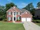 Beautiful two-story brick home with a two-car garage and well-manicured lawn at 10770 Glenhurst Pass, Duluth, GA 30097