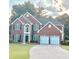 Charming brick home featuring a manicured lawn, black shutters, and a two-car garage at 10770 Glenhurst Pass, Duluth, GA 30097
