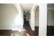 Bright hallway with arched doorways and dark wood floors leading to other rooms at 10770 Glenhurst Pass, Duluth, GA 30097