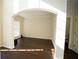Bright living room boasts archway, dark hardwood floors, and a sunny ambiance at 10770 Glenhurst Pass, Duluth, GA 30097