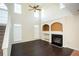 Cozy living room with fireplace, built-in shelving, and soaring ceilings with many windows at 10770 Glenhurst Pass, Duluth, GA 30097