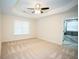 Spacious main bedroom features a tray ceiling, neutral carpet, and ensuite bathroom access at 10770 Glenhurst Pass, Duluth, GA 30097