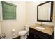 Powder room features granite countertops, a dark wood vanity, and a framed mirror at 10770 Glenhurst Pass, Duluth, GA 30097
