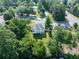 Aerial of the rear of a beautiful 2-story home surrounded by lush, mature trees at 10770 Glenhurst Pass, Duluth, GA 30097