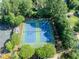 Community tennis courts surrounded by mature trees and green landscaping at 10770 Glenhurst Pass, Duluth, GA 30097